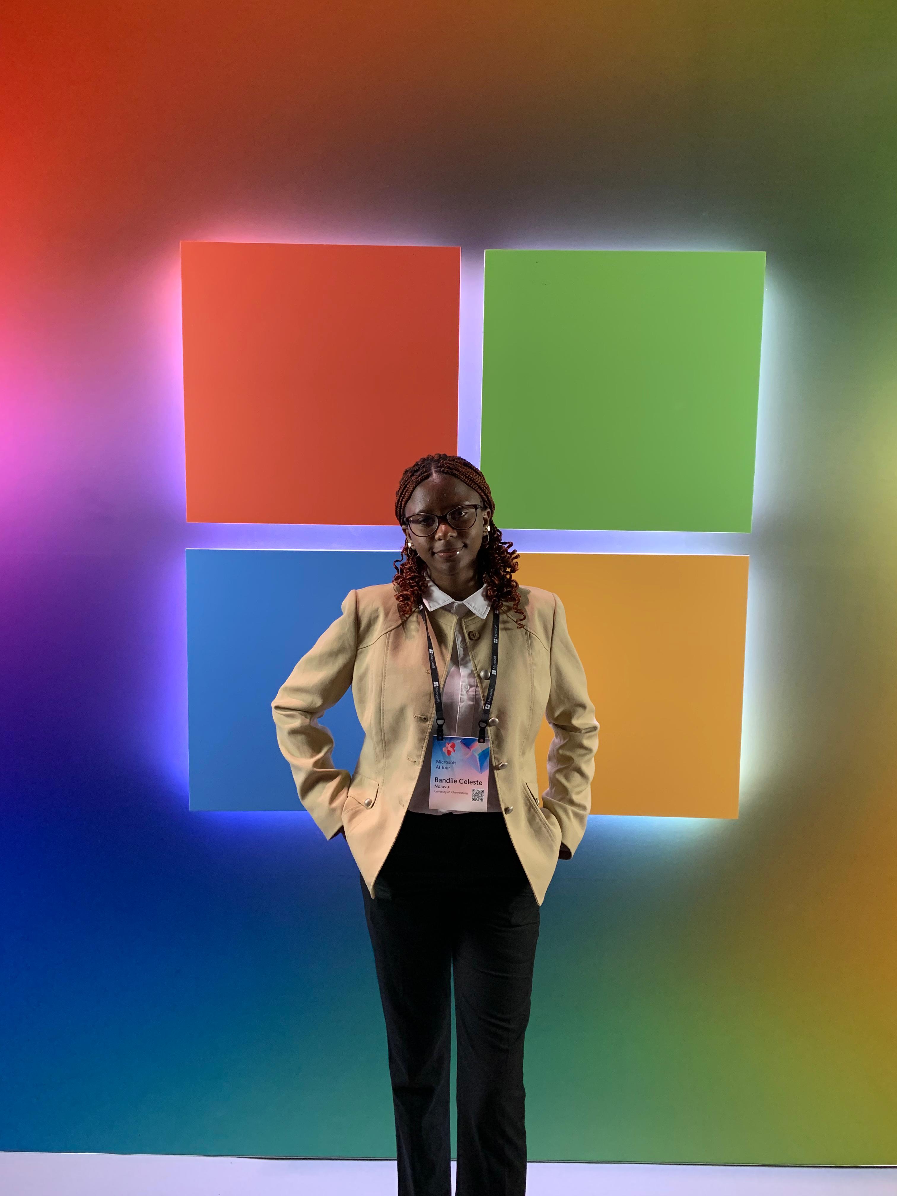 Picture of Celeste Ndlovu standing in front of Microsoft Logo